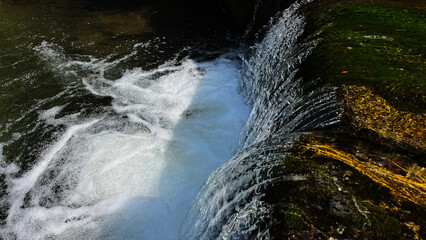 A small mountain river with a flow of water in the Polish mountains. Eastern Sudetes