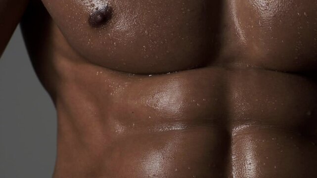 Strong male model, sexy sports athlete fitness personal trainer. Perfect abs, shoulders, and chest. Man with naked torso showing six pack abs. Fitness man showing muscular fitness body.