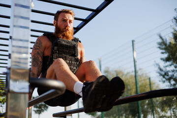 Redhead sportsman training in park in morning