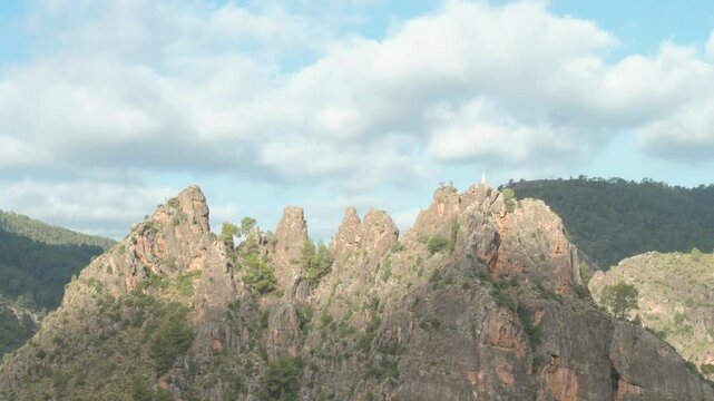 Panoramic view of the mountainous landscape of Los Picarzos of Ayna, Albacete, on a sunny day with some clouds