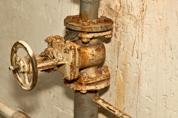 Plumbing. Sewage. Water valve, old rusty faucet in the basement