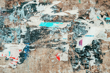Torn ripped poster paper texture on concrete wall