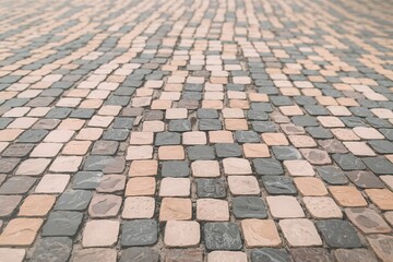 A close-up image of tiled stones with a pattern of alternating light and dark gray