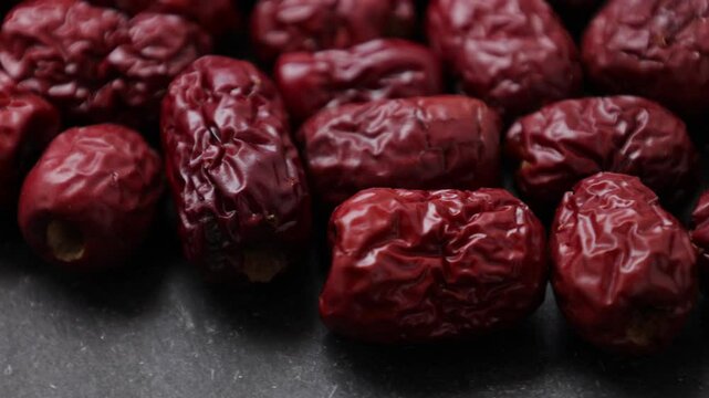dried jujubes fruit on a black background