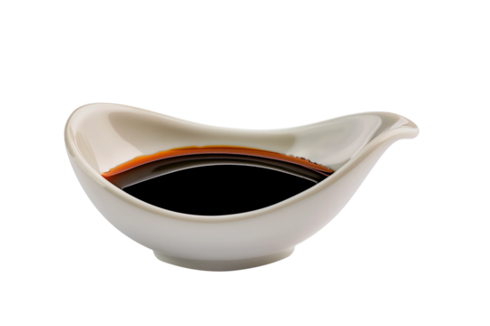 A white porcelain dish containing dark soy sauce isolated on white transparent background.