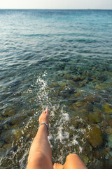Woman's legs at sea. Selective focus.
