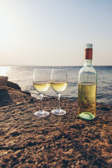 Glasses of wine on the seashore. Selective focus.