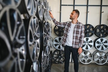 A male customer in a car rim shop