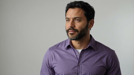 Fototapeta premium adult black hair european man in purple shirt model portrait standing straight on a plain white background for ad concept space for text