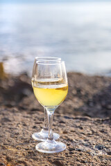 Glasses of wine on the seashore. Selective focus.