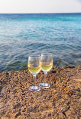 Glasses of wine on the seashore. Selective focus.