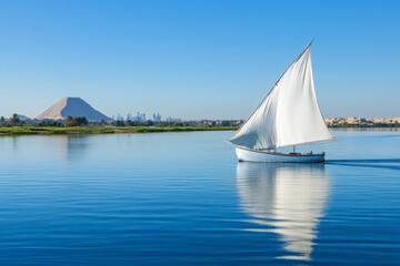 Traditional Egyptian sailboat felucca on Nile River with Giza Pyramids background, Egypt