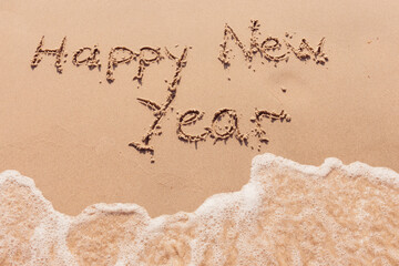 inscription happy new year on the seashore