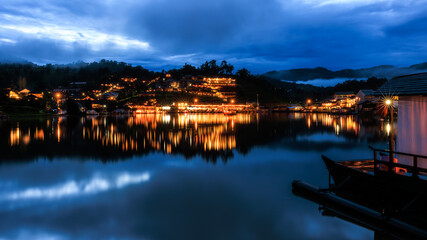 Twilight and over Lighting  Chinese buildings in Ban Rak Thai Village And Blue Sky With Moutain Backgrounds, reflection