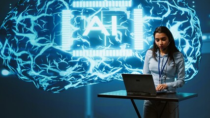 Technician in high tech workspace managing call center tasks, speaking into headset while doing...