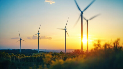 Obraz premium Wind turbines on rolling hills at sunset in a scenic landscape