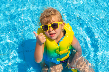 Child playing in the pool. Selective focus.