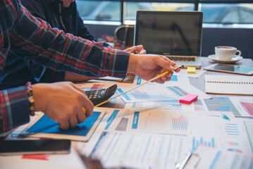 Two businesspeople meeting work at office desk. Teamwork partners team with Business strategy chart...