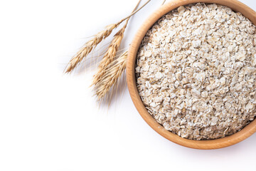Rolled oats, healthy breakfast cereal oat flakes in bowl isolated on white background. Top view. Copy space