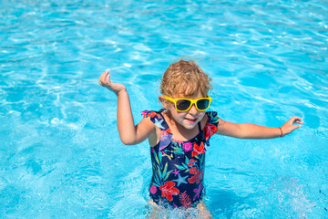 Child playing in the pool. Selective focus.