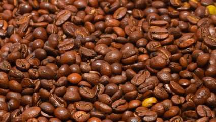 Fototapeta premium Close-up of roasted coffee beans with rich brown texture