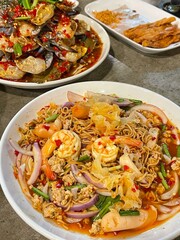 Top view of stewed pork leg on rice with vegetable and boiled egg on wooden background.
