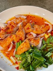 close up of a dish of Asian fusion food: salmon spicy salad