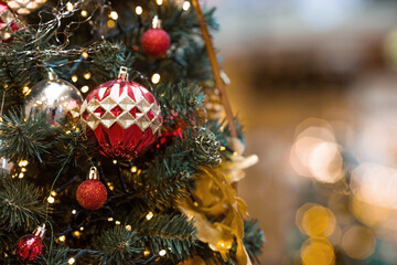 Beautiful festive decorations on the Christmas tree. Close-up. Beautiful Christmas background. The concept of decorations and decor for the new year. New Year's Card 2025