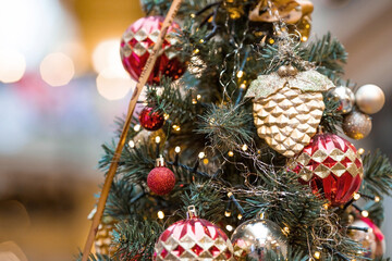 Beautiful festive decorations on the Christmas tree. Close-up. Beautiful Christmas background. The concept of decorations and decor for the new year. New Year's Card 2025