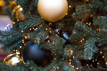 Beautiful festive decorations on the Christmas tree. Close-up. Beautiful Christmas background. The concept of decorations and decor for the new year. New Year's Card 2025