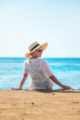 Woman in a hat on the seashore. Selective focus.