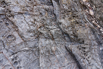 Close up of weathered silver-grey rock on Hemmick beach in Cornwall.