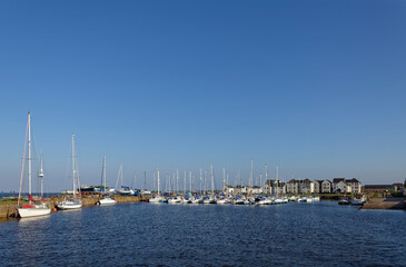 Obraz premium Looking towards the many Yachts and Leisure Craft moored up in the Marina and Harbour of Tayport on the North East Coast of Scotland.