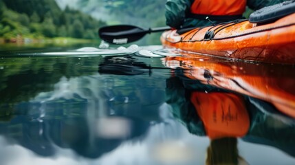 A close-up of a kayaker reflection in the water as they paddle across a still lake, with the surrounding natural beauty mirrored on the surface.