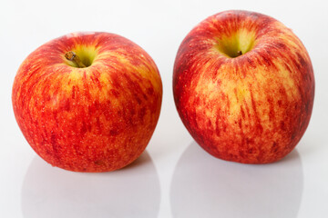 Closeup of ripe organic red apple on white table background. Selective focus.