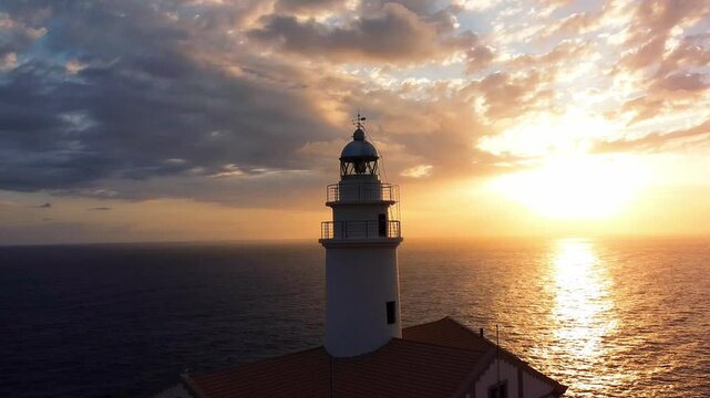 Capdepera lighthouse at sunrise with dramatic sky