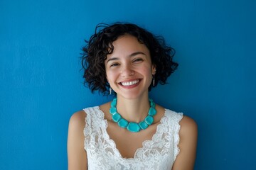 Beautiful woman against a blue background in a portrait