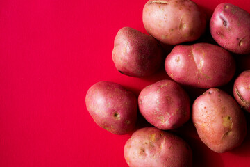 Red potatoes against a red background 