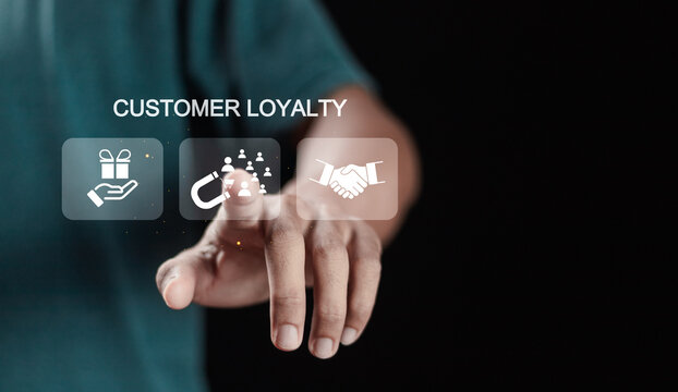 Customer loyalty concept, good relationship between customers and brands. Person touching customer loyalty icons on virtual screen for building loyalty and retention.