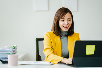 Brightly smiling businesswoman working on tablet at office Female employees check business...
