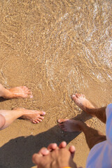 Woman and man holding hands on the seashore. Selective focus.