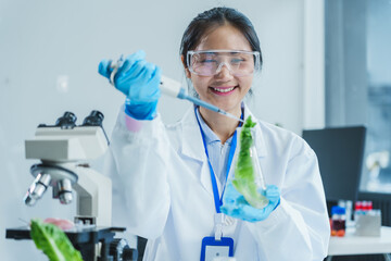 Two Asian women in a lab work on food research, using a microscope, petri dish, and test tubes filled with chemical solutions. They study vegetables, pork, and plants for GMO traits and nutrition.