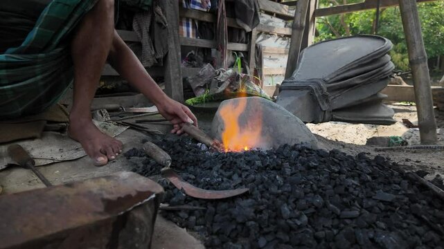 Bangladeshi blacksmith working in Sundarbans, Barisal, Harta, Bangladesh