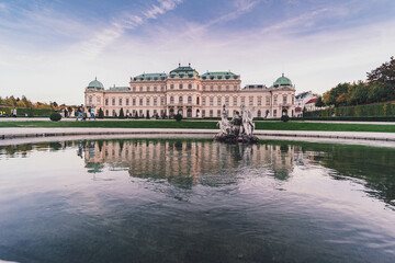 view of belvedere palace in vienna at sunset with pink clouds