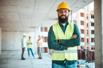 Confident Construction Worker on Building Site with Colleagues