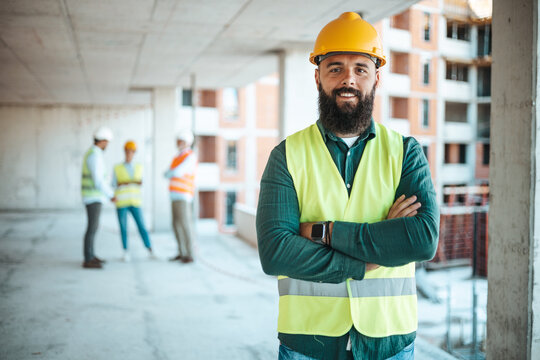 Confident Construction Worker at Building Site with Team