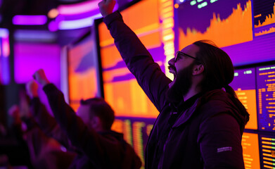 Obraz premium Excited traders celebrating a successful stock market rally in front of large screens with market data. 