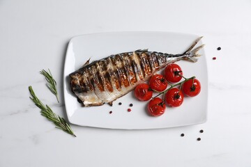 Delicious grilled mackerel, tomatoes, peppercorns and rosemary on white marble table, flat lay