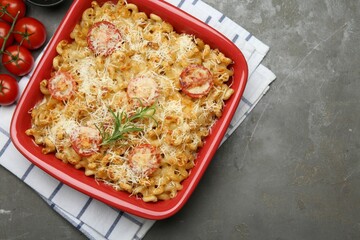 Delicious al forno pasta in baking dish on grey table, flat lay