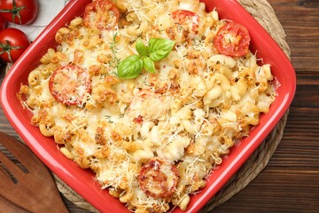 Delicious al forno pasta in baking dish on wooden table, top view